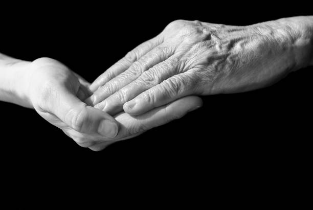 istock Daughter holding her mother's hand 1159835724