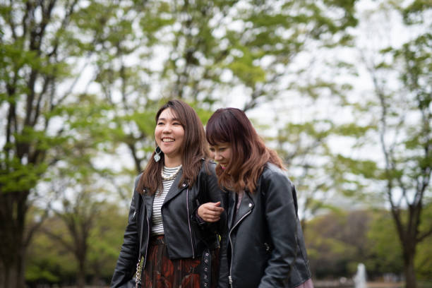 istock Female couple walking arm in arm 1159837374