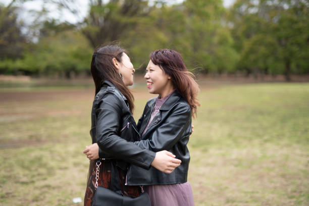 istock Female couple embracing in park 1159837418