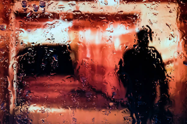 Neon lights behind water drops close up