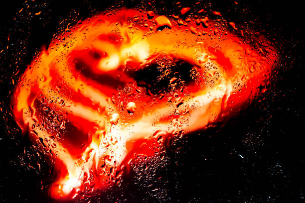 Neon lights behind water drops close up