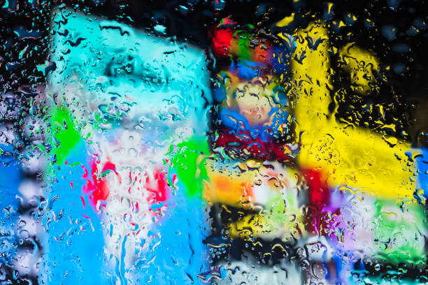 istock Neon lights behind water drops close up 1159839292
