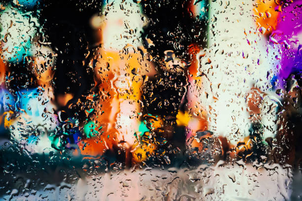 istock Neon lights behind water drops close up 1159839914