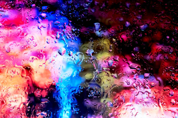 istock Neon lights behind water drops close up 1159840357