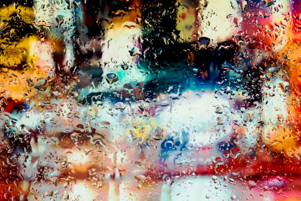 istock Neon lights behind water drops close up 1159840667