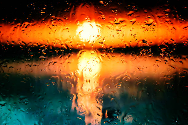 Neon lights behind water drops close up