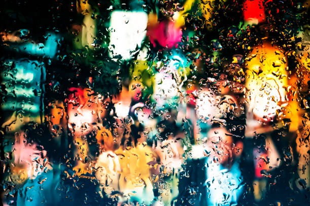 istock Neon lights behind water drops close up 1159842475