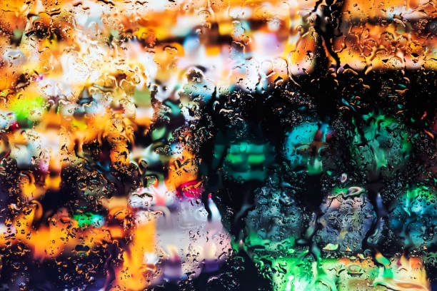 istock Neon lights behind water drops close up 1159842731