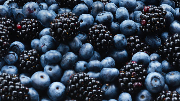 istock Blackberry and  blueberry background. Top view. 1159842823