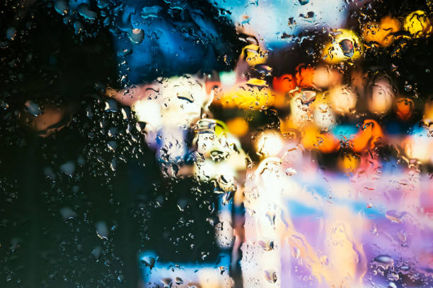 istock Neon lights behind water drops close up 1159842868