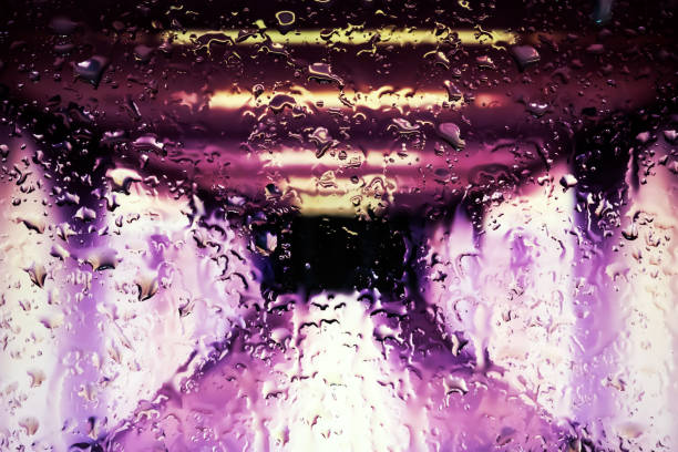 istock Neon lights behind water drops close up 1159843727
