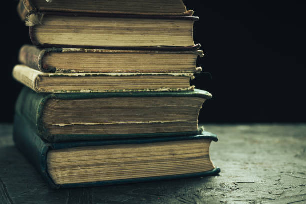 istock Old books on a wooden table black background. 1159844065