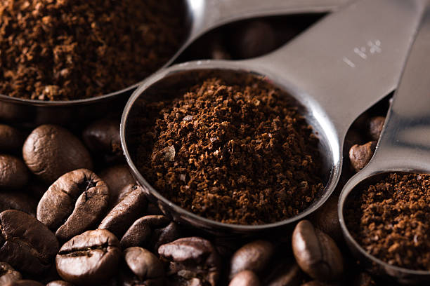 Coffee Measuring spoons with ground coffee and coffe beans. attraction studio photography stock pictures, royalty-free photos & images