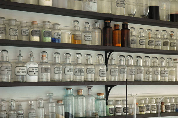 istock Antique glass bottles on shelves 115984499