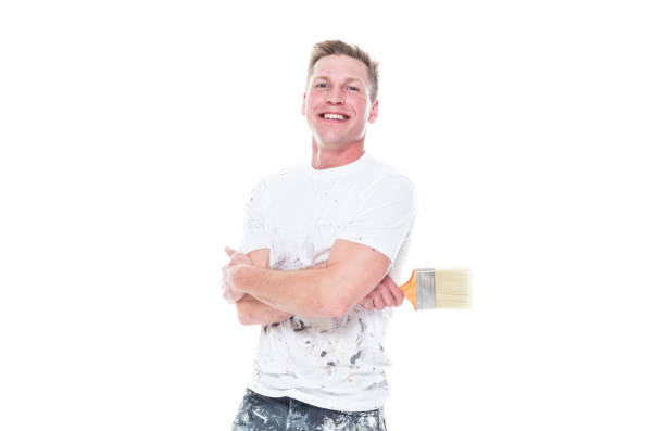 istock Young attractive male painter standing on white background - smiling 1159845658