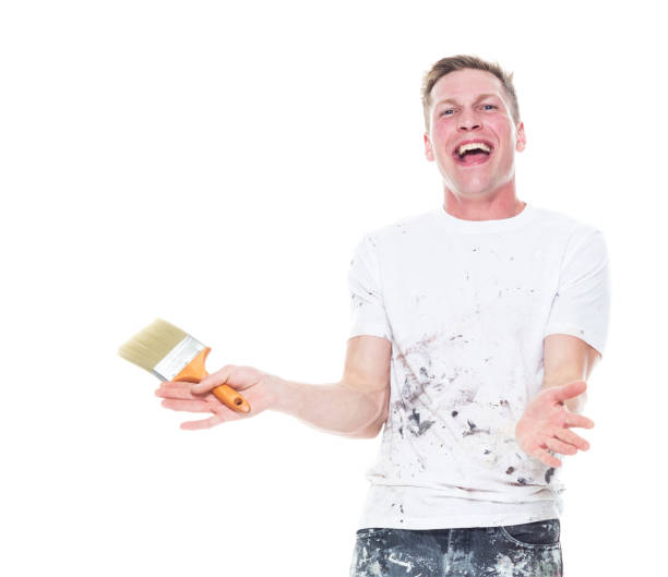istock Handsome young male painter wearing staned clothes  on white background - clapping 1159845674
