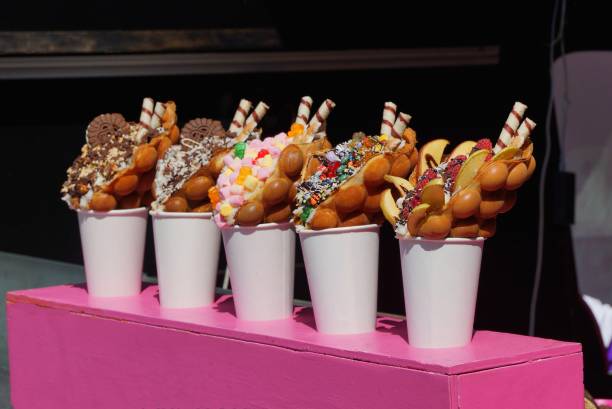 istock a row of white paper cups with colored candies 1159847113