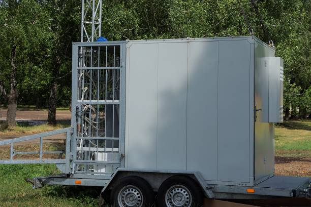 istock gray metal box trailer on wheels stands in green grass 1159847253