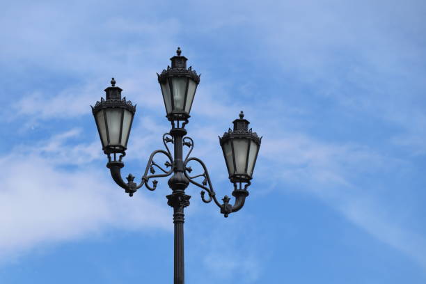 istock Black lamppost in the background of blue sky 1159847514