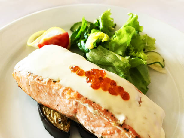 istock Grilled salmon fish served with egg plant, tomato and salad on a white plate. Design element, texture, backdrop 1159847533