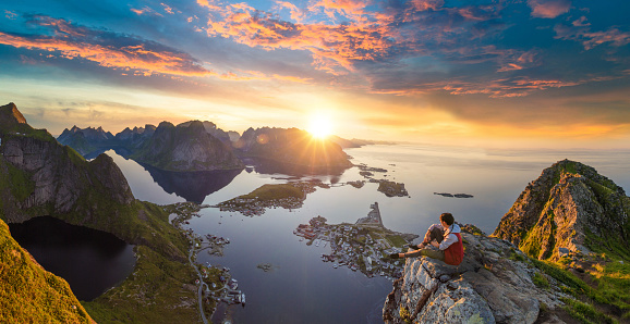 Traveller enjoy summer view of Lofoten Islands in Norway with sunset scenic