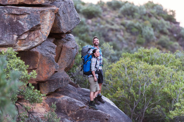 istock Couple standding on a boulder in nature taking in the view 1159848320