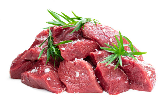 istock Sliced raw beef with tarragon herb isolated on white 1159848724