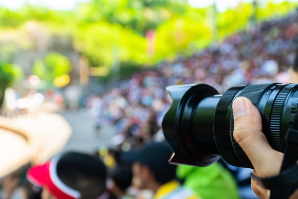 istock Photographer taking photo and crown background. 1159850166