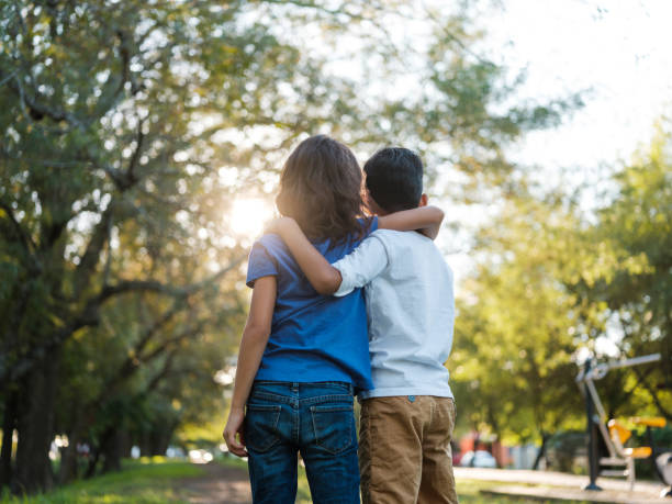 istock Little pals with arms around each other 1159851691