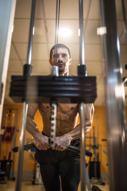 istock Muscular man working out in gym, strong male torso 1159851891