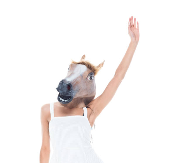 istock Cute female wearing a horse head 1159852667