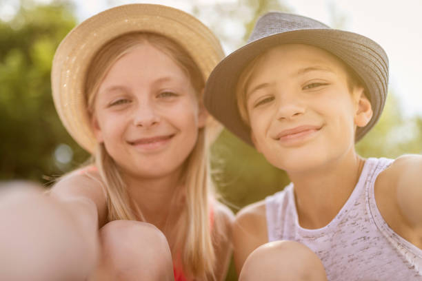 istock Brother and sister doing selfie with phone 1159852860