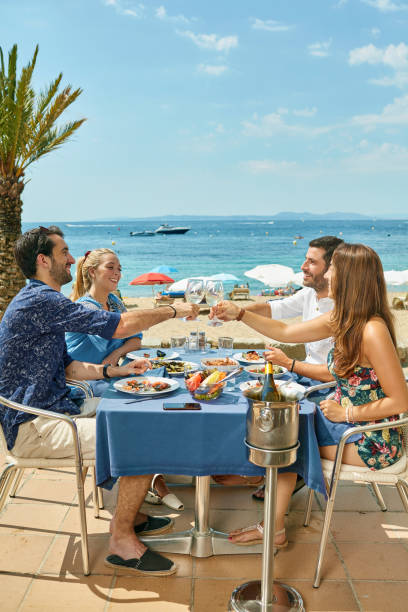 istock Young Couples Toasting Over Lunch at Sunny Costa Brava Cafe 1159852915