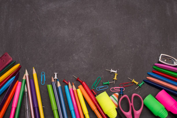 istock School supplies on blackboard background ready for your design. 1159855151