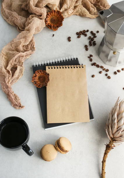 istock Autumn composition. Cup of coffee, macaroons , dried flowers, notebook on grey background.  Flat lay, top view, copy space 1159855727