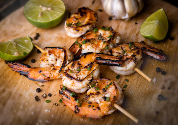 istock Skewer shrimps burnt grilled with spice seasoning. 1159857023