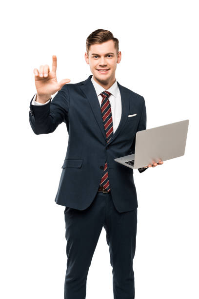 istock cheerful man pointing with finger while holding laptop isolated on white 1159857052