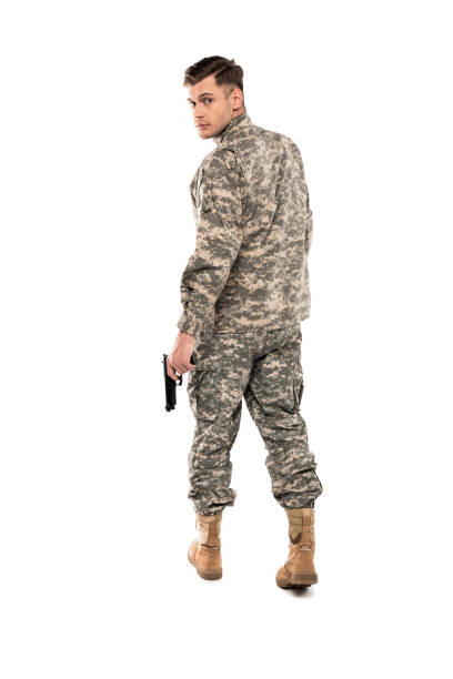 handsome man in military uniform holding gun isolated on white