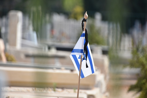 The flag of Israel in a cemetery