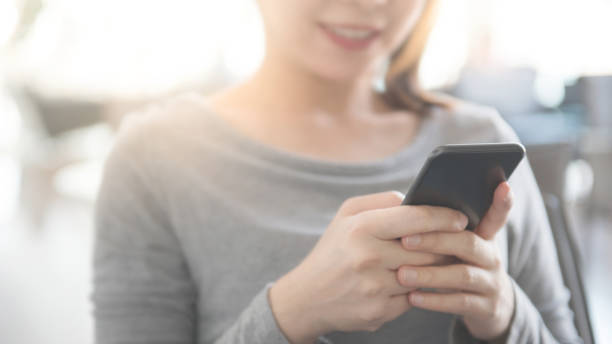 istock Woman hand holding mobile phone, She using in mobile applications and multimedia programs. copy space 1159857349