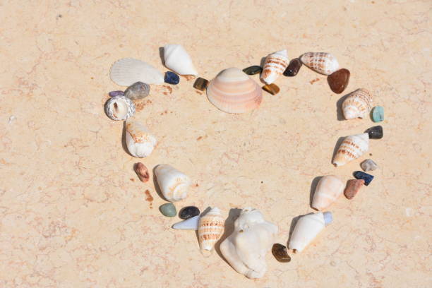 istock Heart made of sea shells and pebbles 1159858040