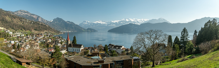 Weggis, Switzerland - March 30, 2019: Beautiful view on Lake Luzern and Alps above the Weggis village, Switzerland during sunny spring day