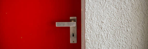 istock closed metal door with a handle and plastered wall. 1159858541