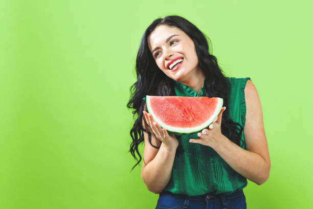 istock Young woman holding watermelon 1159859709