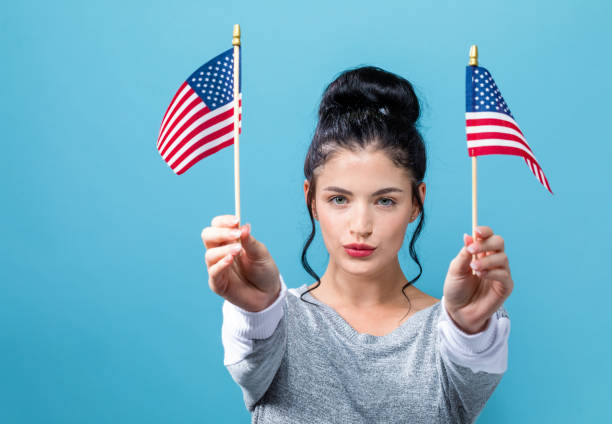 istock Young woman with American flag 1159859771