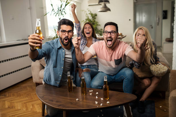 istock Friends watching sport on tv. 1159859926