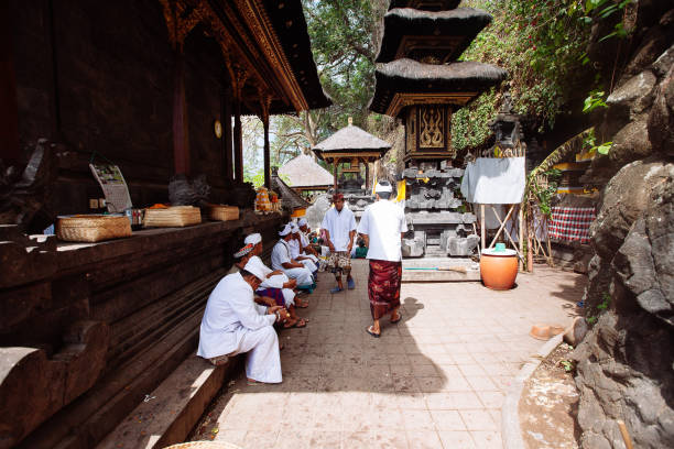Bali, Indonesia - Apr 04, 2016 : Balinese family in traditional costume attending Meprani Ceremony at tample in Batur.