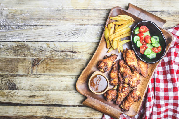 istock Grilled chicken wings on wooden background. 1159862169