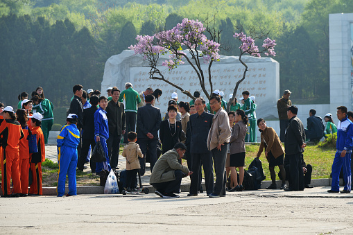 Pyongyang, North Korea - May 1, 2019: People gather on a square to celebrate May 1st Labor Day on the Pyongyang street