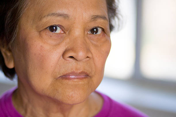 istock Elderly Asian woman looking at camera 115986577